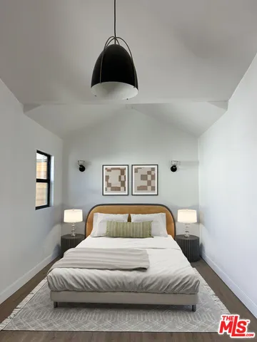 a bedroom with a bed and a large window
