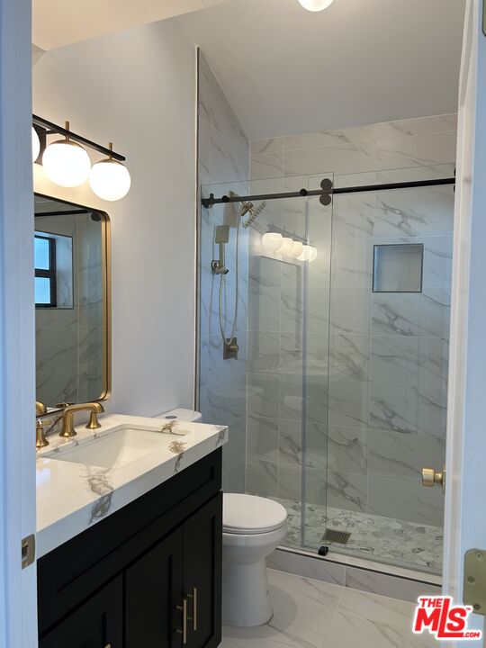 17209 Keswick Street Lake Balboa, CA 91406 - Photo 9 of 19 a bathroom with a sink a toilet and shower