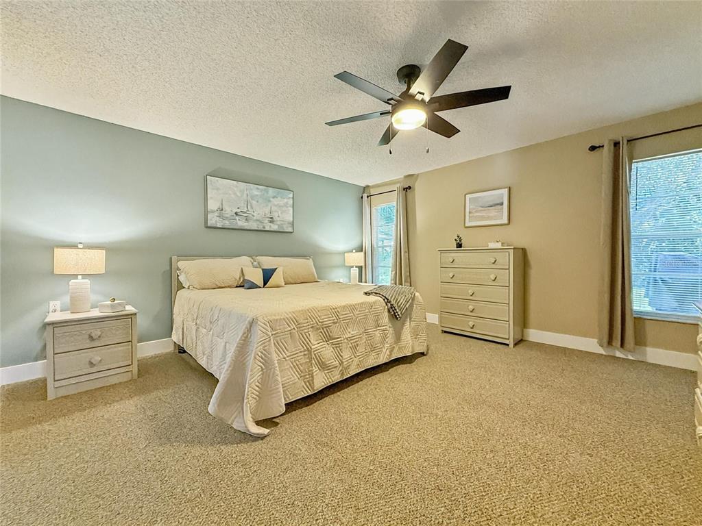 2436 Deer Trail Lane Spring Hill, FL 34606 - Photo 12 of 56 a spacious bedroom with a bed and dresser