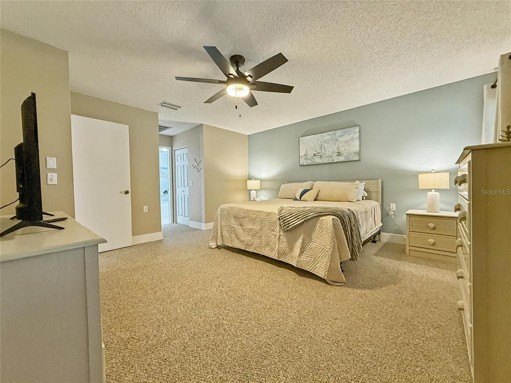 2436 Deer Trail Lane Spring Hill, FL 34606 - Photo 13 of 56 a bedroom with a bed and a flat screen tv