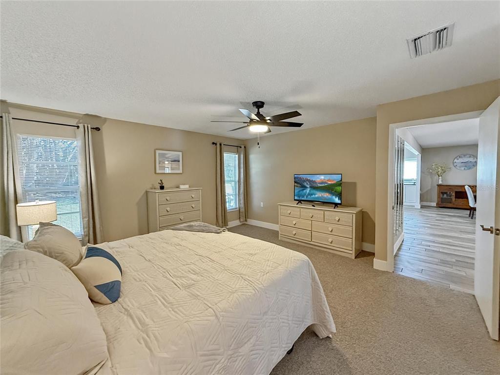2436 Deer Trail Lane Spring Hill, FL 34606 - Photo 14 of 56 a bedroom with a bed and a large mirror