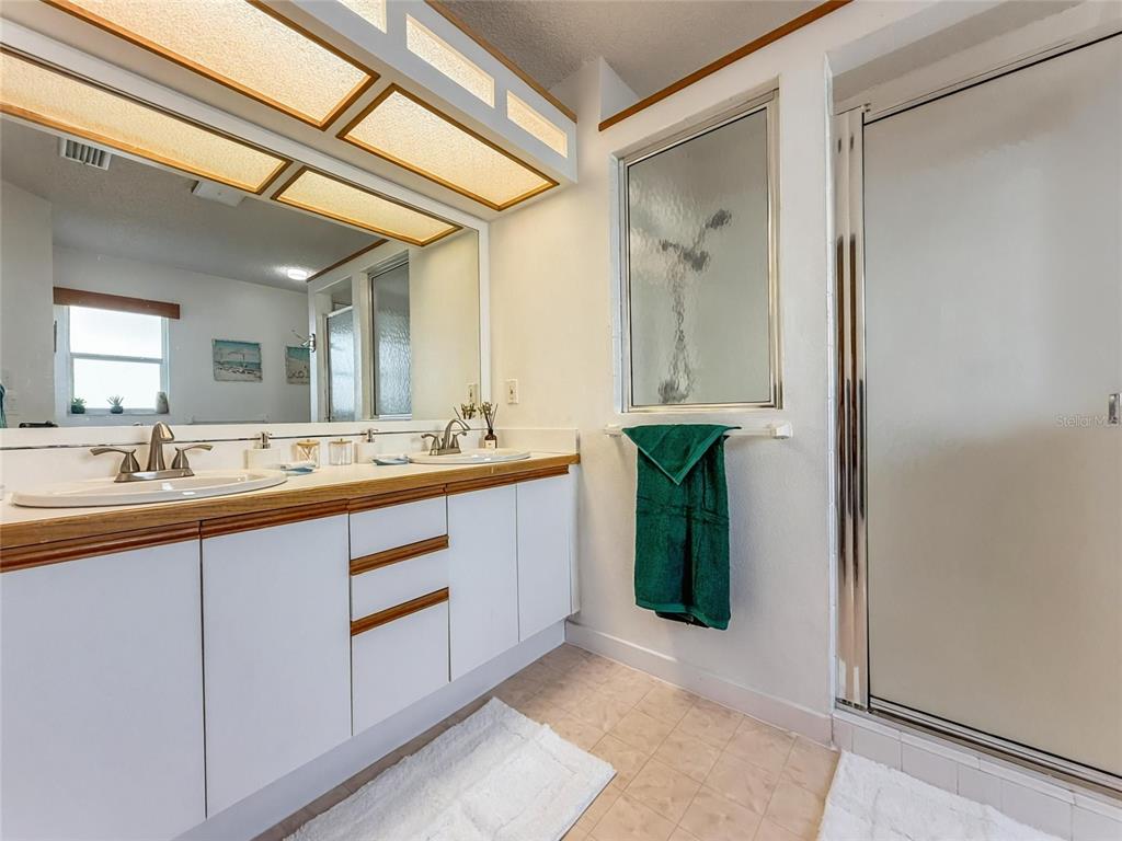 2436 Deer Trail Lane Spring Hill, FL 34606 - Photo 17 of 56 a bathroom with a double vanity sink and a mirror