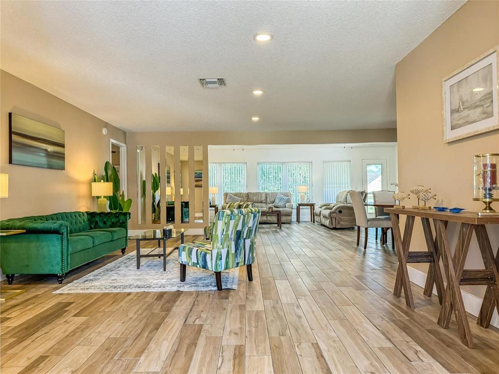 2436 Deer Trail Lane Spring Hill, FL 34606 - Photo 2 of 56 a living room with furniture and wooden floor