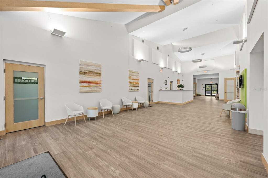 2436 Deer Trail Lane Spring Hill, FL 34606 - Photo 35 of 56 a view of a living room and kitchen with wooden floor