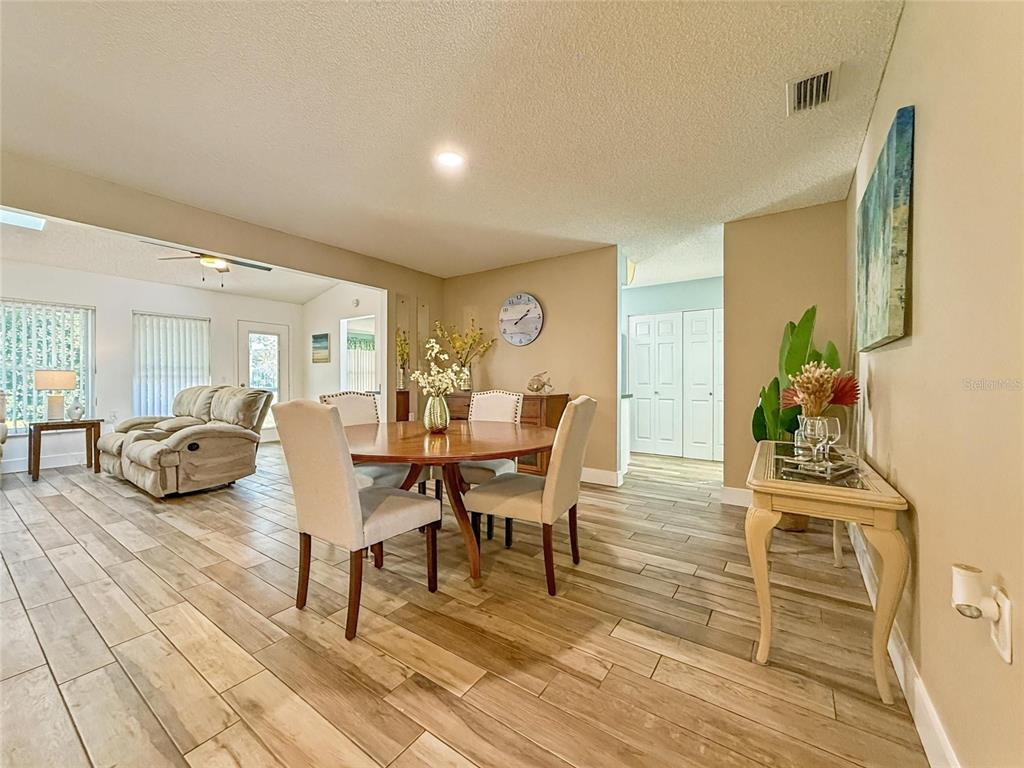 2436 Deer Trail Lane Spring Hill, FL 34606 - Photo 4 of 56 a view of a dining room with furniture and wooden floor