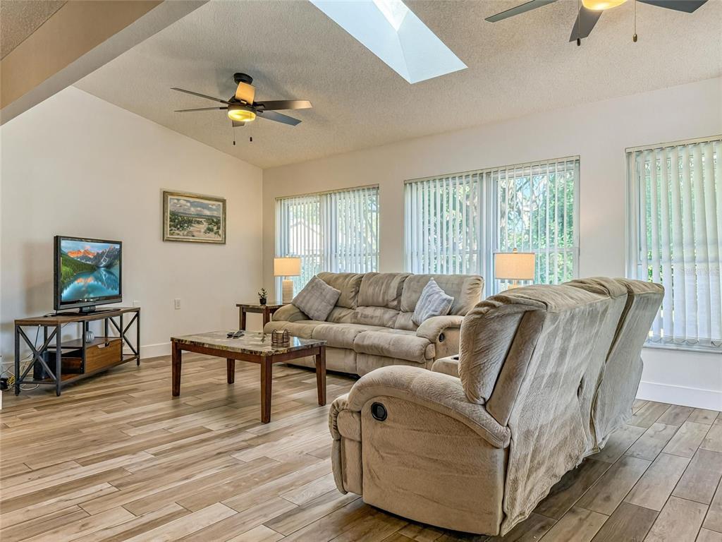 2436 Deer Trail Lane Spring Hill, FL 34606 - Photo 6 of 56 a living room with furniture and a wooden floor