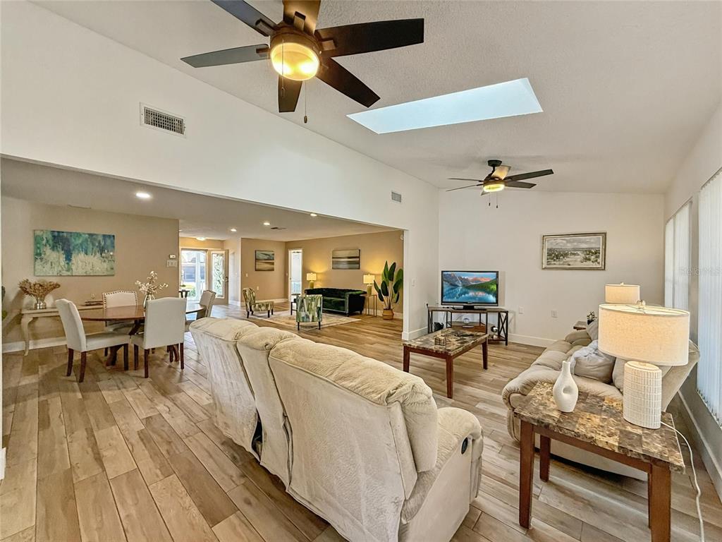 2436 Deer Trail Lane Spring Hill, FL 34606 - Photo 7 of 56 a living room with furniture and a flat screen tv