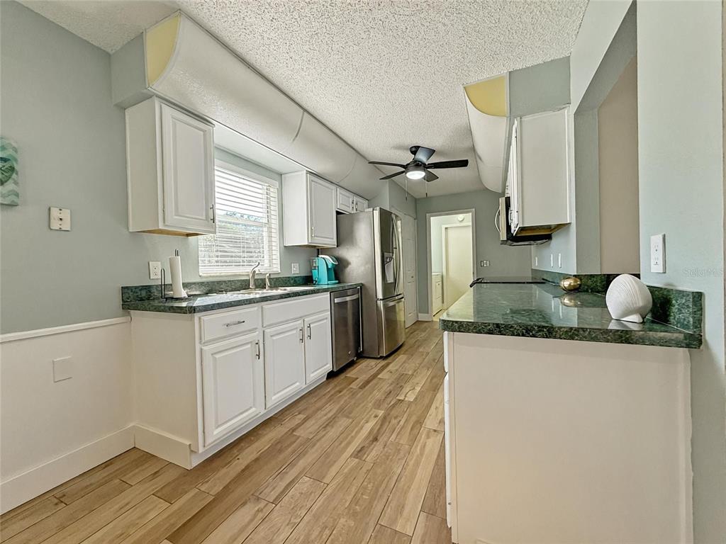 2436 Deer Trail Lane Spring Hill, FL 34606 - Photo 8 of 56 a kitchen with granite countertop a sink and cabinets