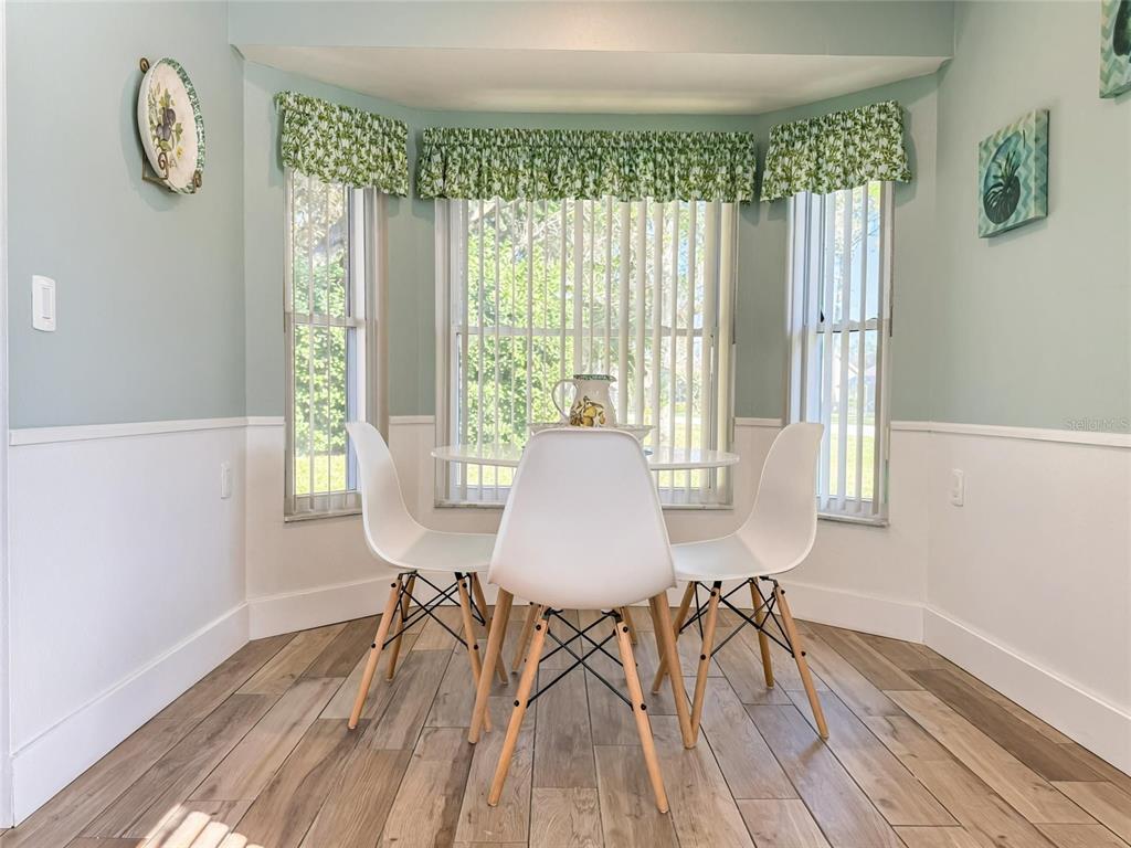 2436 Deer Trail Lane Spring Hill, FL 34606 - Photo 9 of 56 a view of a dining room with furniture window and wooden floor