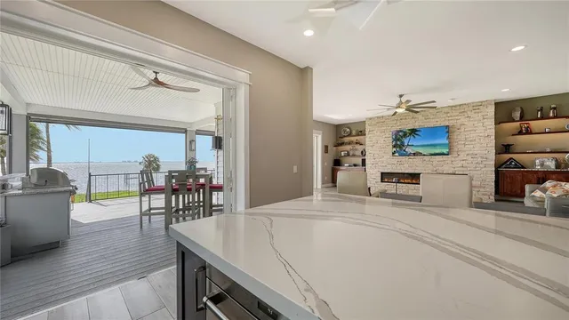 a living room with stainless steel appliances kitchen island granite countertop furniture and a kitchen view
