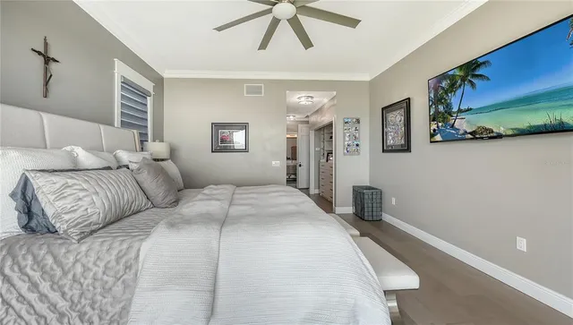 a bedroom with a large bed and a chandelier