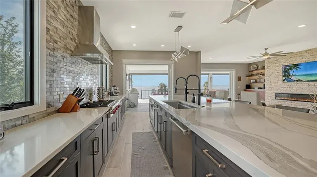 a kitchen with counter top space a sink appliances and cabinets