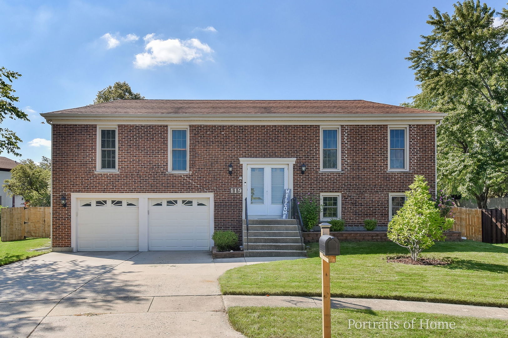 a front view of a house with garden