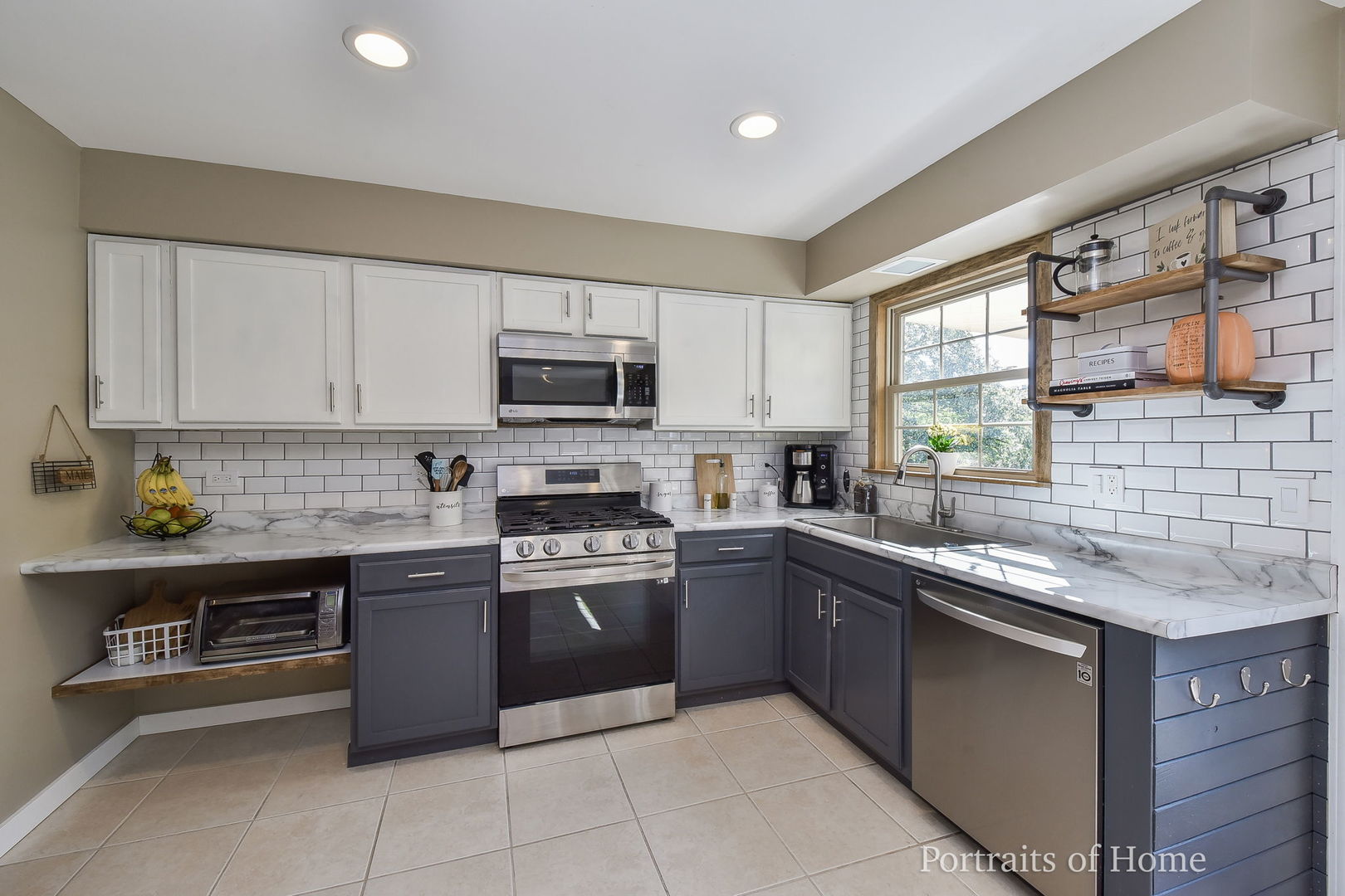 119 Reston Court Roselle, IL 60172 - Photo 9 of 25 a kitchen with stainless steel appliances granite countertop a sink counter space cabinets and a window