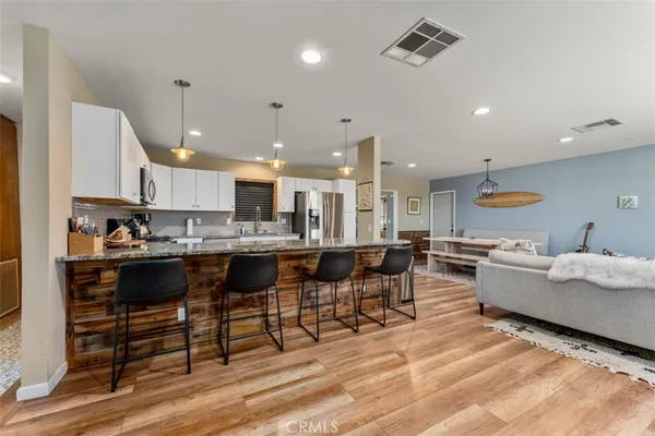 a large kitchen with a table and chairs