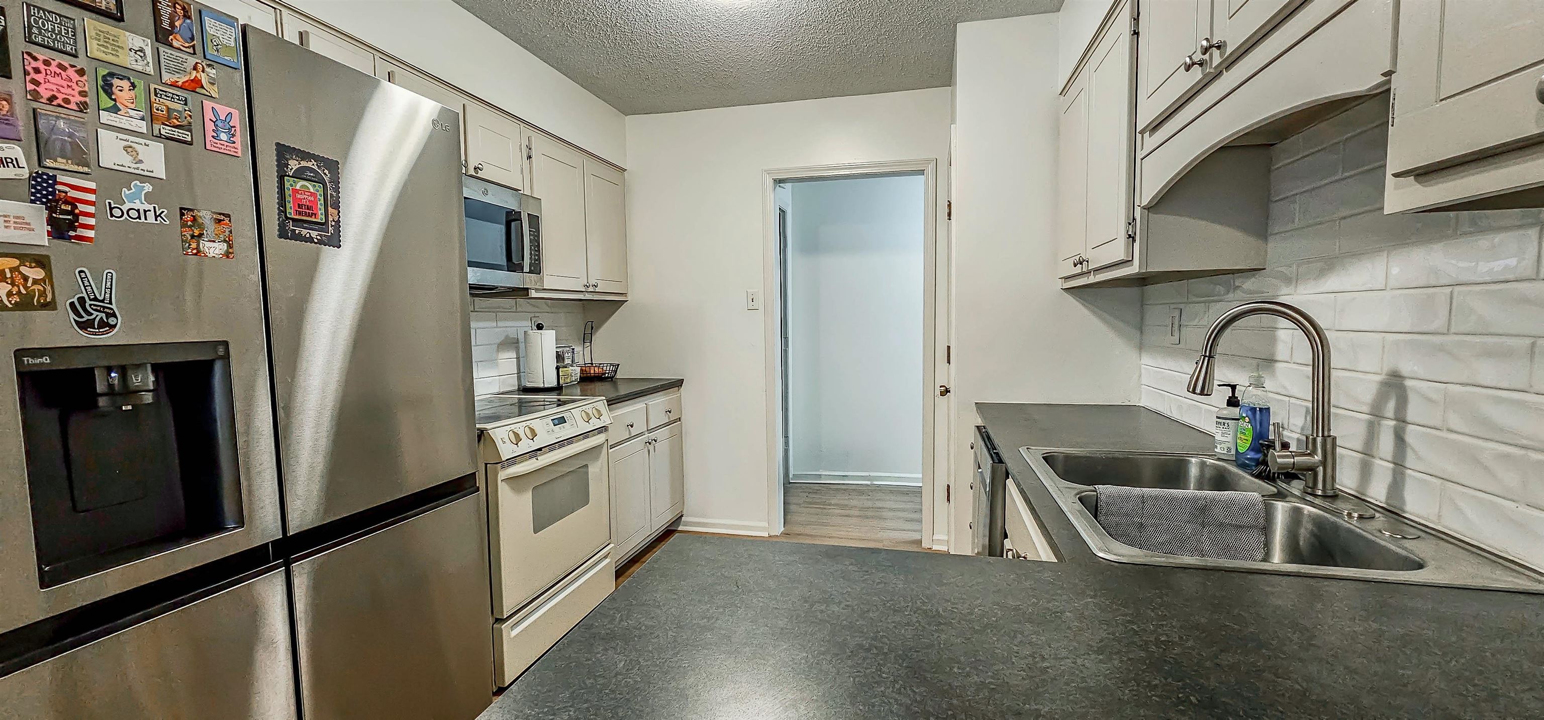 3204 Ruskin Road Memphis, TN 38134 - Photo 11 of 24 a kitchen with stainless steel appliances granite countertop a sink and a refrigerator