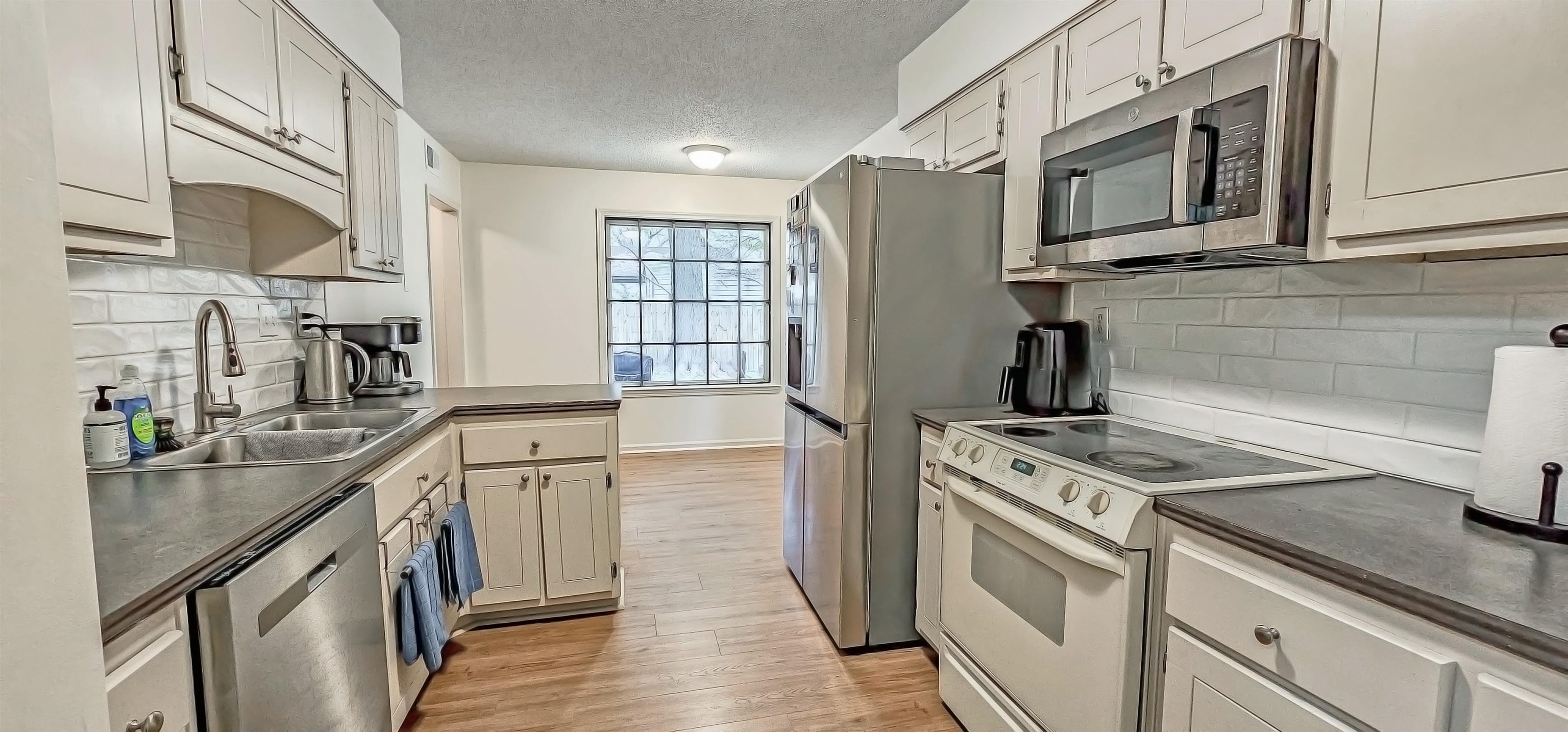 3204 Ruskin Road Memphis, TN 38134 - Photo 12 of 24 a kitchen with stainless steel appliances granite countertop a sink stove and refrigerator