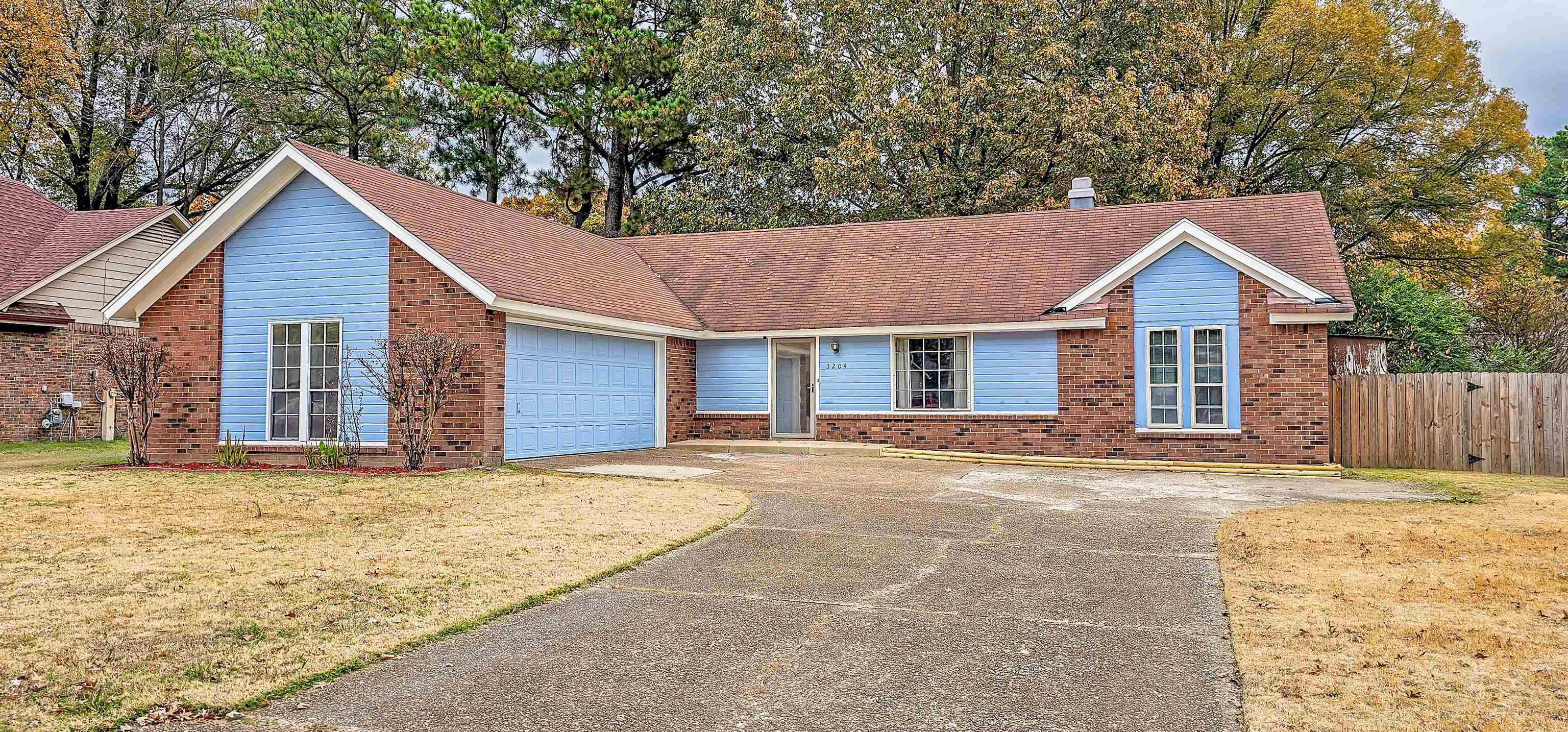 3204 Ruskin Road Memphis, TN 38134 - Photo 3 of 24 a front view of a house with a garden and yard