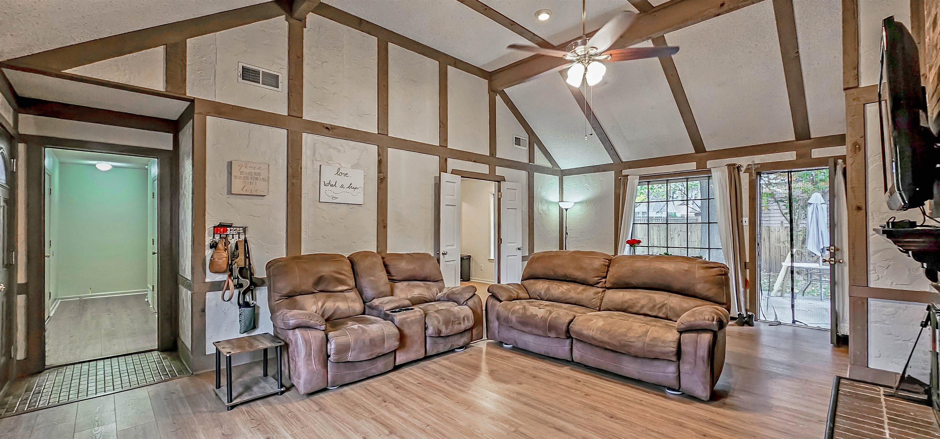 3204 Ruskin Road Memphis, TN 38134 - Photo 4 of 24 a living room with furniture a flat screen tv and a floor to ceiling window