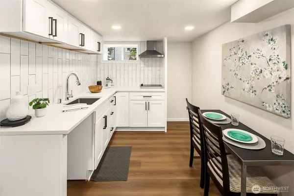 a kitchen with stainless steel appliances granite countertop a sink a stove and wooden cabinets