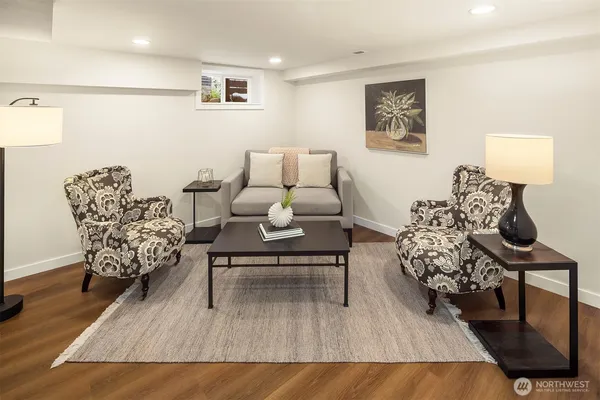 a living room with furniture and a wooden floor