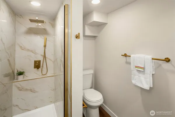 a bathroom with a toilet and a shower