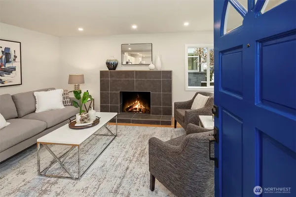 a living room with furniture and a fireplace