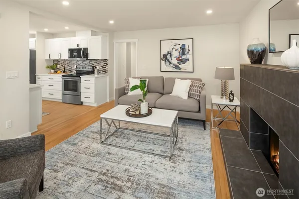 a living room with furniture and kitchen view