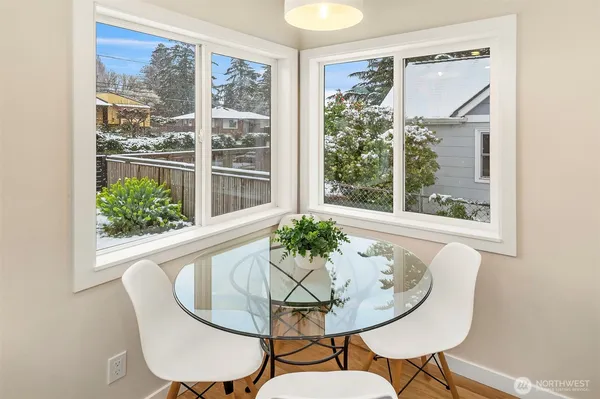 a dining room with furniture window and wooden floor