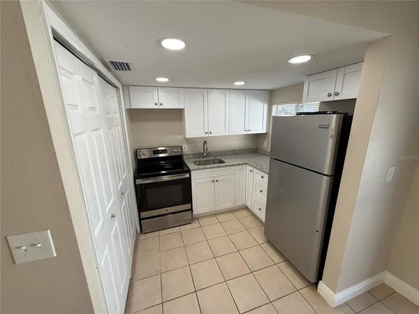 a kitchen with a refrigerator a stove a sink and a refrigerator