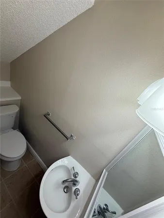 a bathroom with a toilet and a mirror