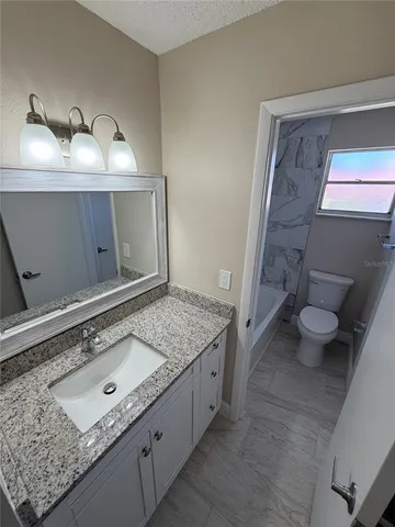 a bathroom with a toilet and a tub