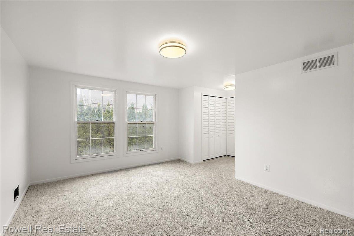 3403 Crooks Road Royal Oak, MI 48073 - Photo 21 of 29 Spare room featuring light colored carpet and baseboards