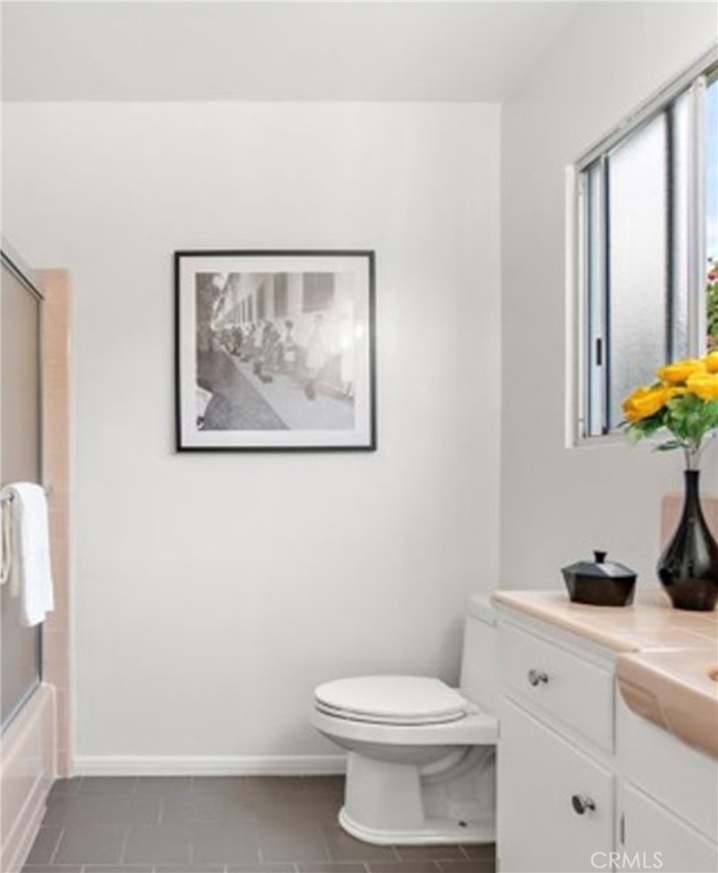 2135 East Florida Street, Unit 2 Long Beach, CA 90814 - Photo 11 of 13 a bathroom with a toilet a sink and a mirror
