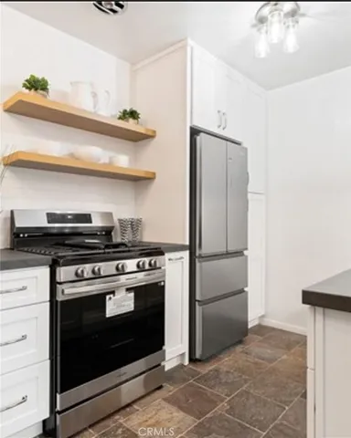 a kitchen with stainless steel appliances a stove and a refrigerator