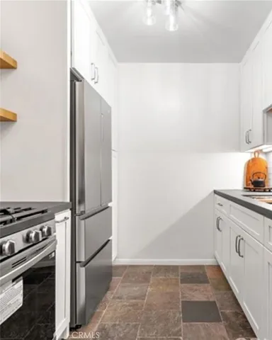 a kitchen with a refrigerator and a stove