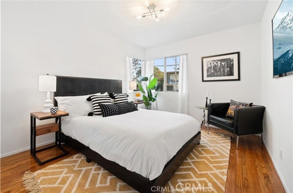 2135 East Florida Street, Unit 2 Long Beach, CA 90814 - Photo 10 of 13 a bedroom with a bed and wooden floor