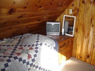 284 Ocean View Drive Wellfleet, MA 02667 - Photo 20 of 34 a bedroom with a bed and a mirror