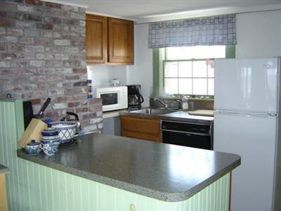 284 Ocean View Drive Wellfleet, MA 02667 - Photo 6 of 34 a kitchen with stainless steel appliances granite countertop a sink stove and refrigerator