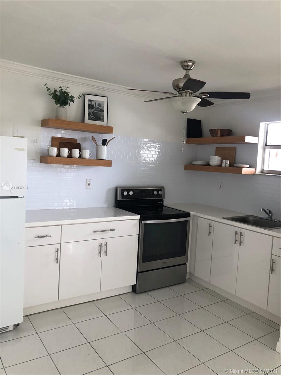 10740 Southwest 3rd Street, Unit 204 Sweetwater, FL 33174 - Photo 4 of 8 a kitchen with cabinets and appliances
