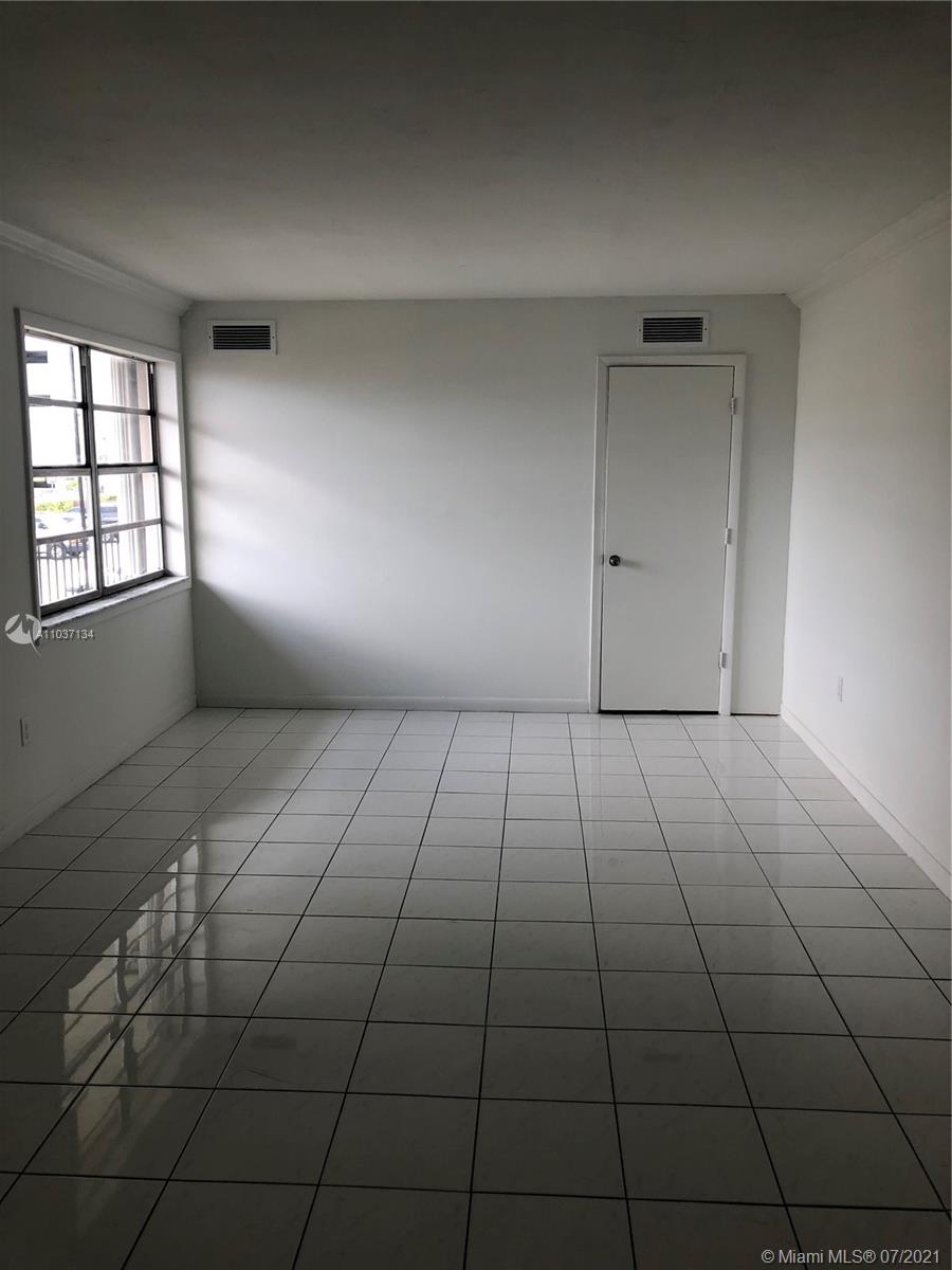 10740 Southwest 3rd Street, Unit 204 Sweetwater, FL 33174 - Photo 5 of 8 a view of an empty room and window