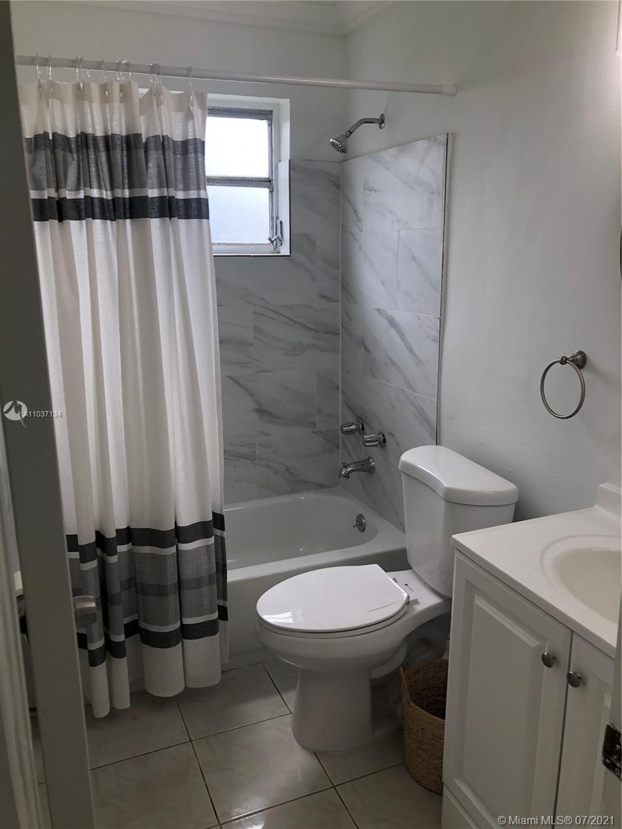 10740 Southwest 3rd Street, Unit 204 Sweetwater, FL 33174 - Photo 6 of 8 a bathroom with a toilet and a shower