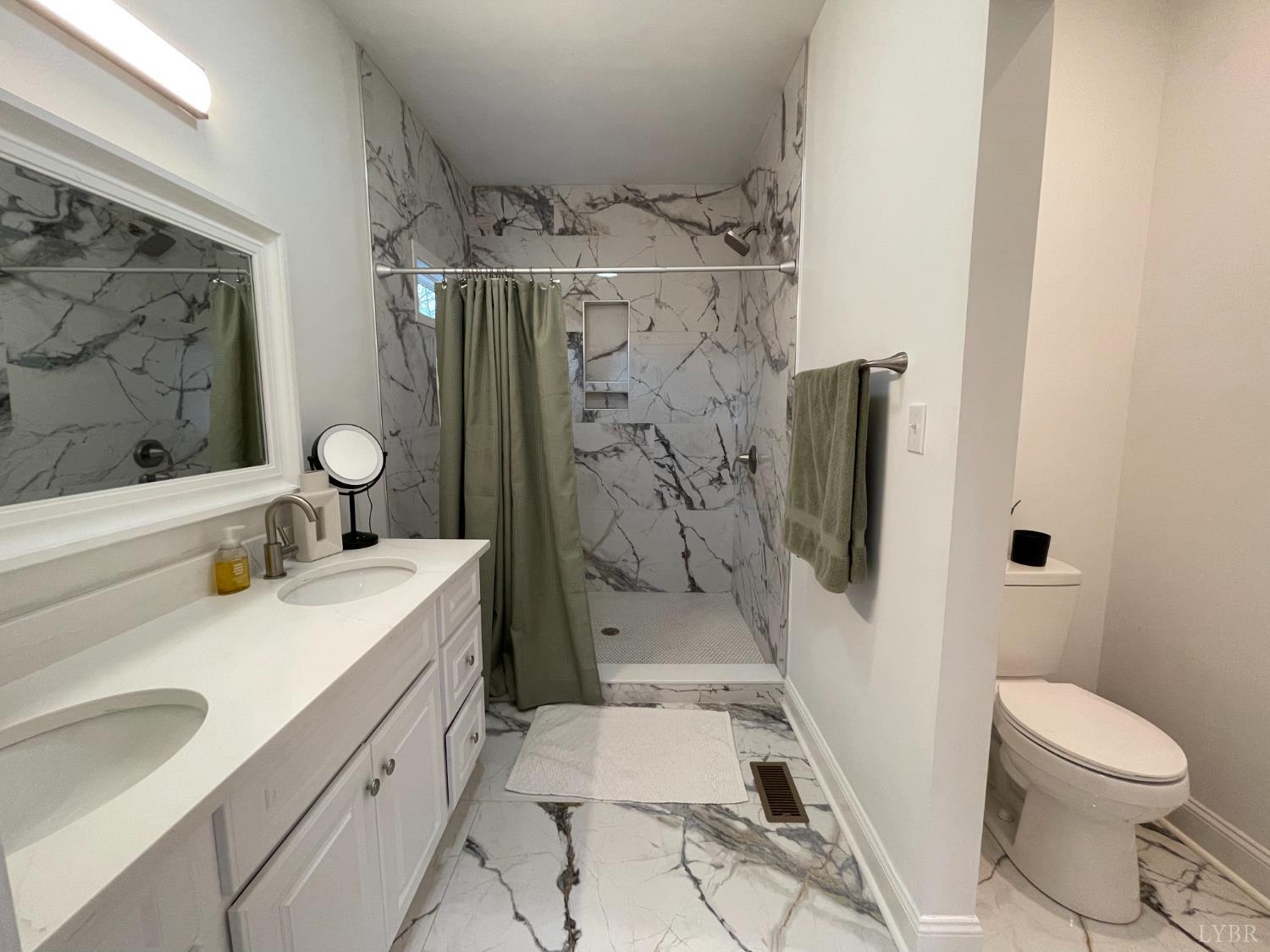 708 Grove Street Bedford, VA 24523 - Photo 10 of 22 a bathroom with a sink toilet and shower