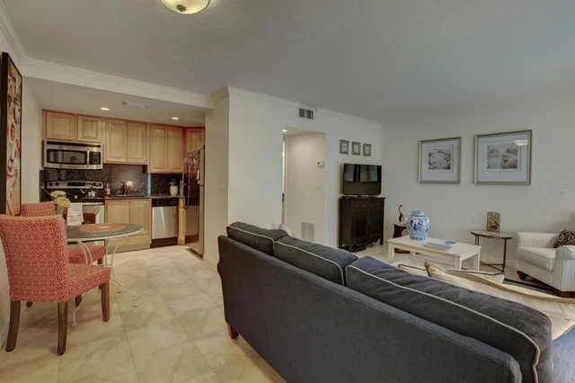 a living room with furniture and kitchen view
