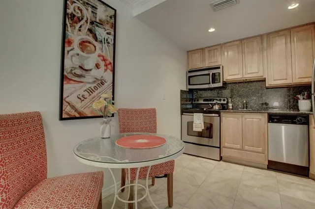 a kitchen with stainless steel appliances granite countertop a sink and a stove
