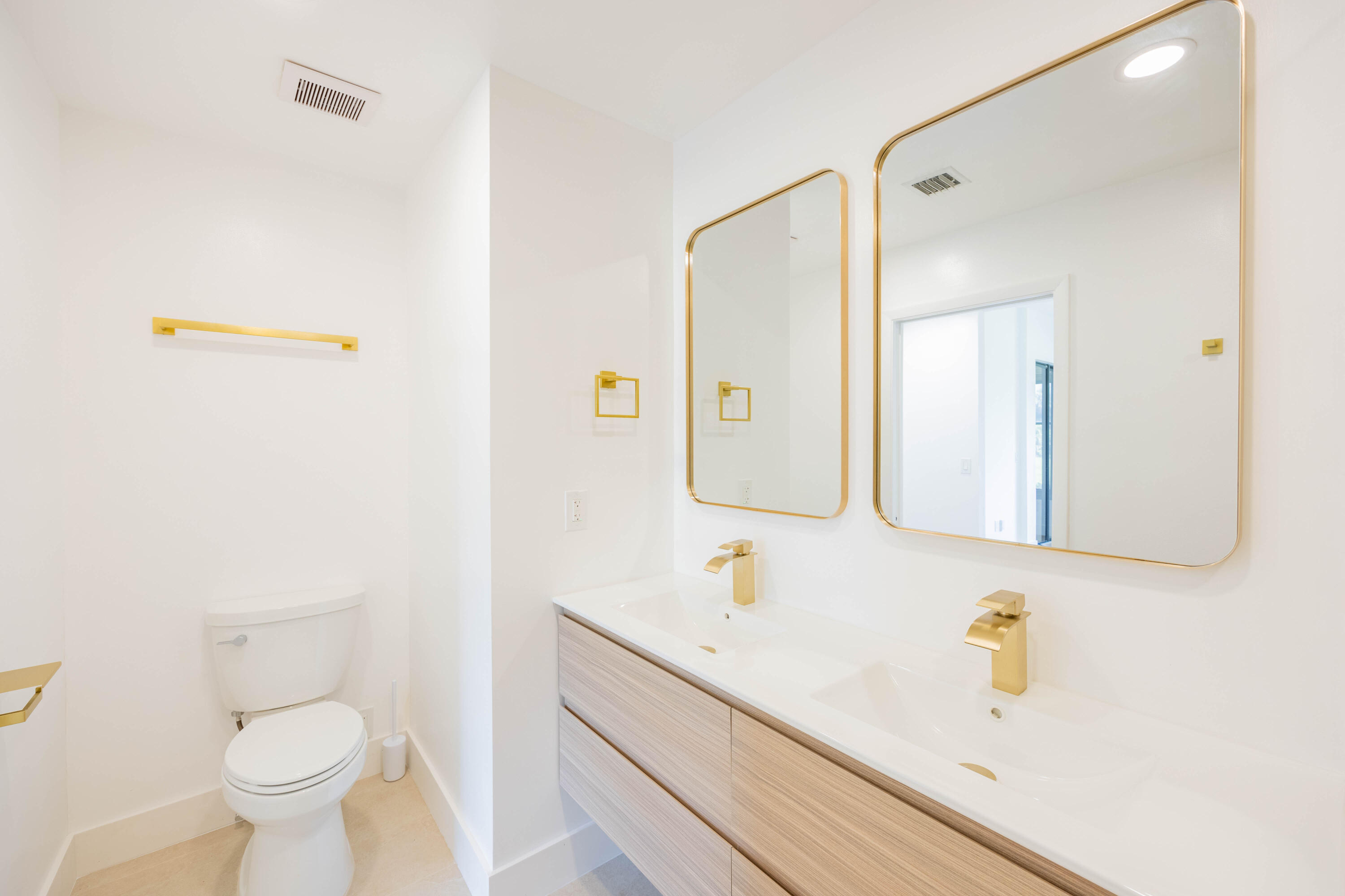 7520 La Paz Boulevard, Unit 104 Boca Raton, FL 33433 - Photo 29 of 56 a bathroom with a sink a toilet and mirror