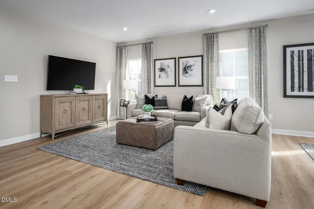 a living room with furniture and kitchen view