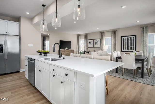a kitchen with a sink cabinets and wooden floor