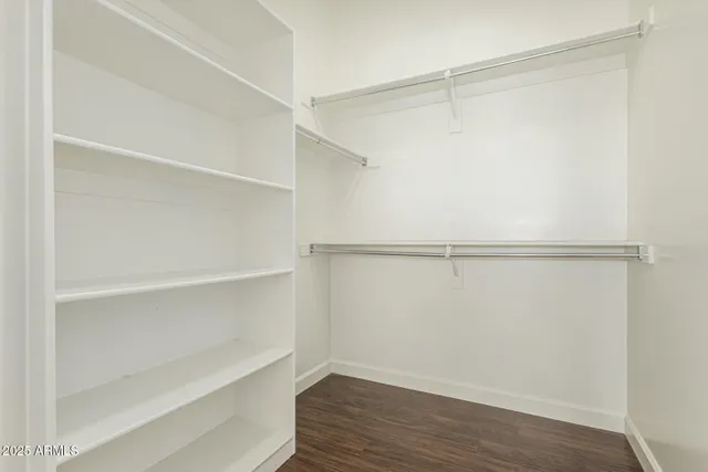 a bathroom with a granite countertop sink toilet and mirror