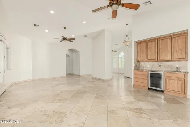 a view of an empty room with a kitchen